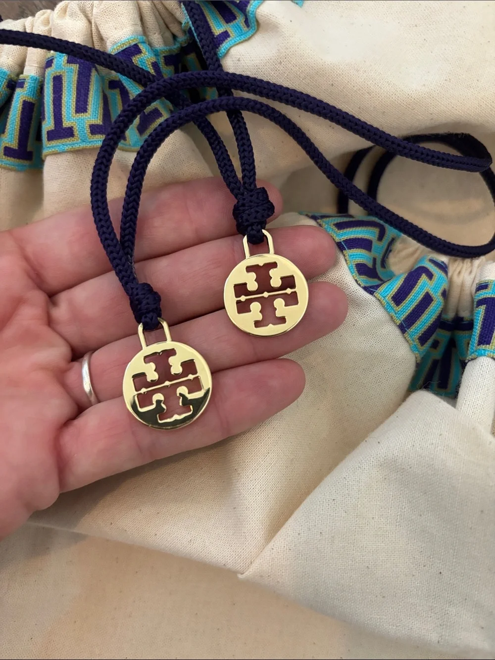 Set of 2 Tory Burch drawstring dust bags, canvas with gold charm